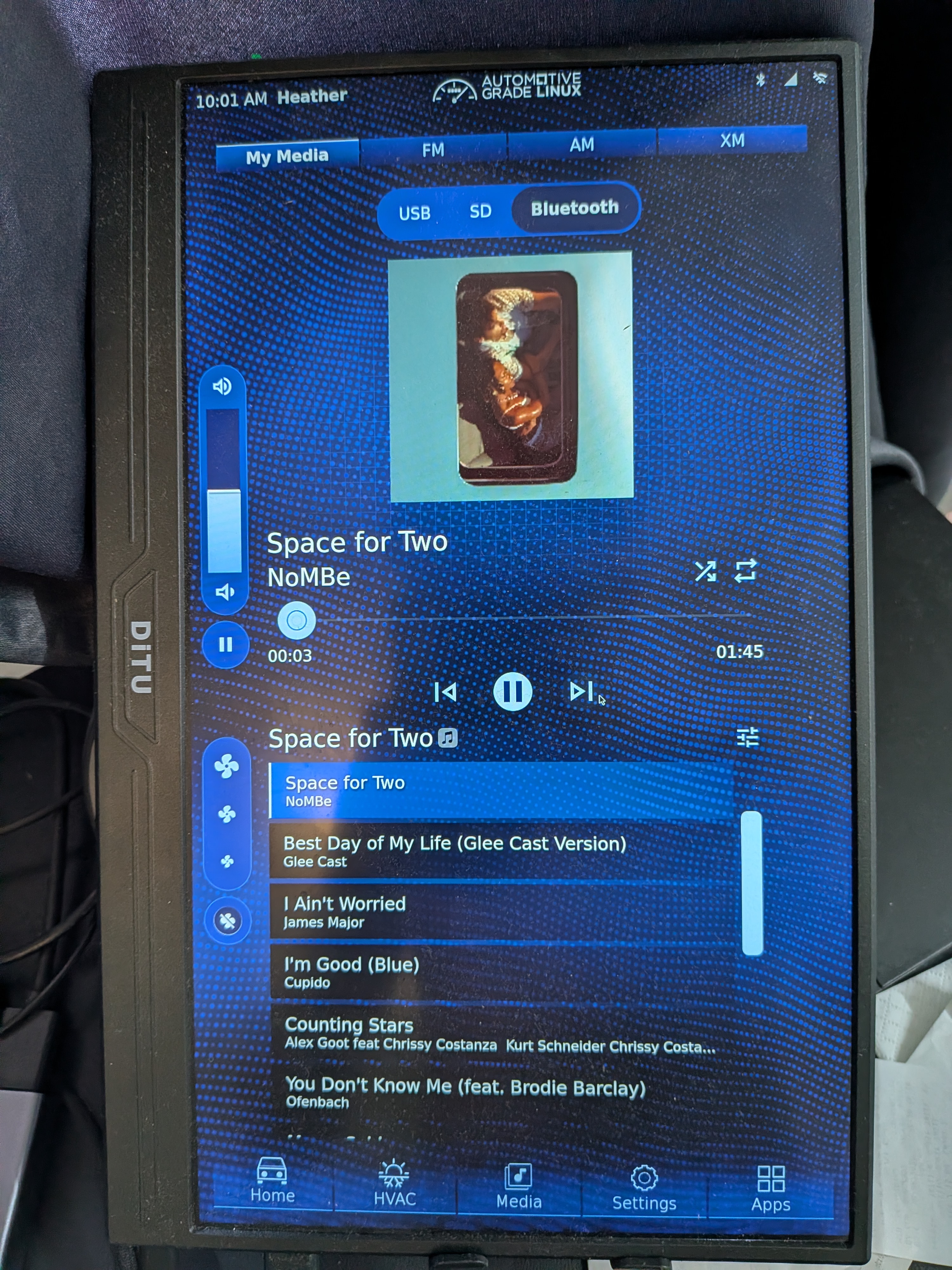 Full AGL Bluetooth media screen playing I Ain't Worried by OneRepublic with cover art, metadata, progress, playback controls, and a media item row.